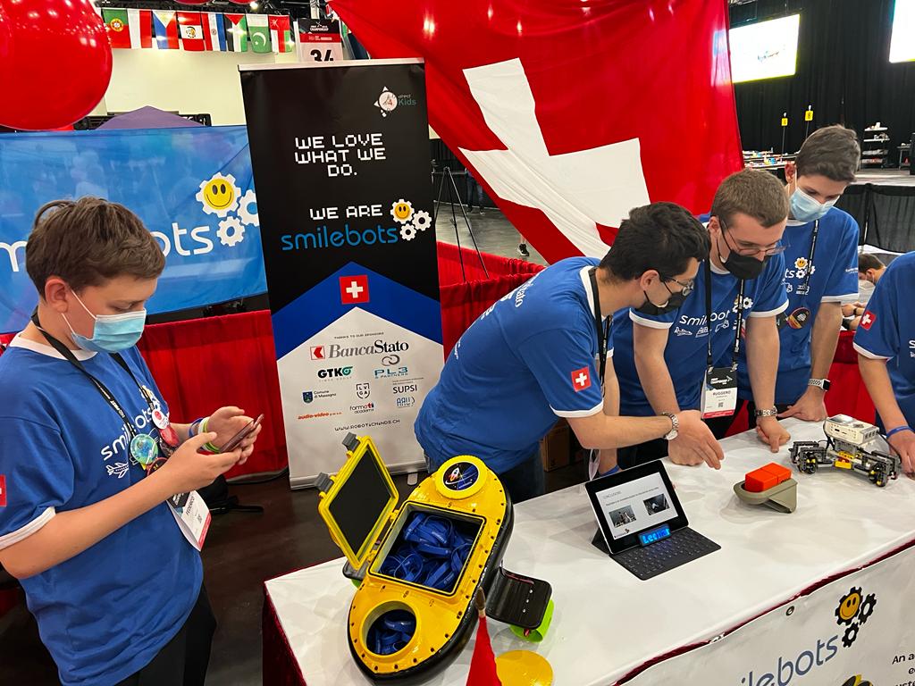Il team ticinese Smilebots (incarnato dai giovanissimi Federico Corsale, Federico Colapicchioni, Leonardo Domeniconi, Pietro Botturi e Ruggero Domeniconi) ha conquistato il 18esimo posto assoluto su 108 squadre partecipanti a Houston nella finale della competizione “First Lego League” il 23 e 24 aprile 2022: oltre alla prova di robotica vera e propria, gli Smilebots hanno presentato un progetto innovativo di un sistema di trasporto merci, lacustre, ecologico e a guida autonoma, visto che il tema portante della competizione quest'anno era legato al tema "Cargo Connect"
